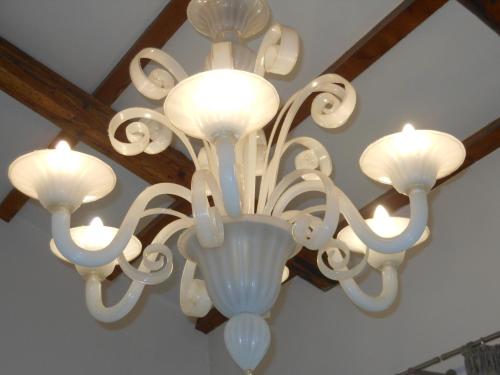 a large white chandelier hanging from a ceiling at Appartamenti A San Marco in Venice