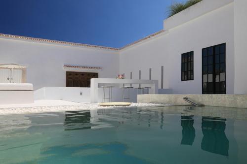 a white house with a swimming pool in front of it at Dar Sabri in Nabeul