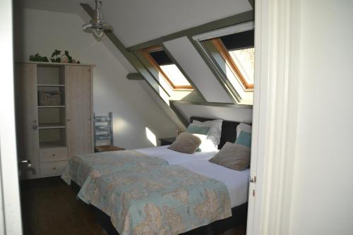 a bedroom with a bed and some windows at Mourits Hoeve in Woerden