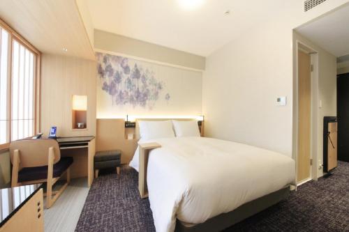 a hotel room with a bed and a desk at Richmond Hotel Premier Kyoto Ekimae in Kyoto