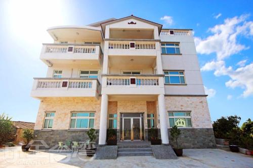 a villa with a view of a building at 嚨口秘境觀海民宿The heart of the sea in Jinning