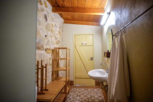 a bathroom with a sink and a toilet in it at PaxosBlue Suites & Villas in Gaios