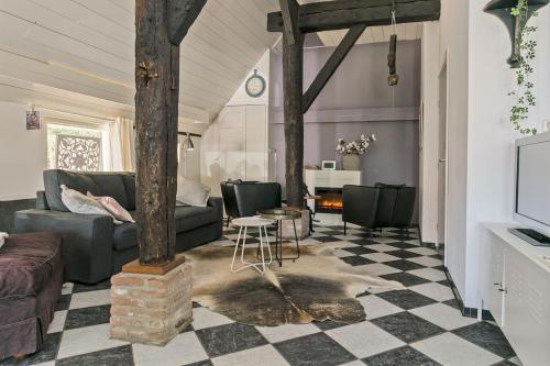 a living room with a couch and a table at Appartement "in de wolken" in Gees in Gees