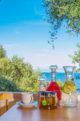 a table with two glass bottles on top of a table at PaxosBlue Suites & Villas in Gaios