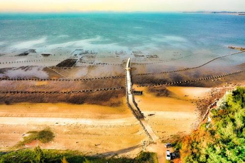 an aerial view of a suspension bridge over the water at 嚨口秘境觀海民宿The heart of the sea in Jinning