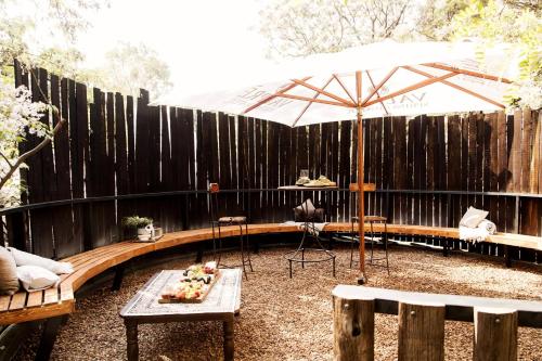 a patio with an umbrella and a table at Kleinkaap Boutique Hotel in Centurion