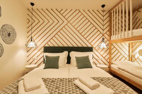 a bedroom with a bed with a wooden ceiling at Dream Boutique Apartments in Rīga