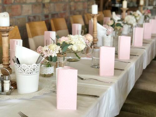 a table with pink cards and flowers on it at Hotel Restaurant FIDI in Wolfsthal