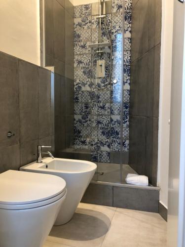 a bathroom with a toilet and a sink and a shower at B&B Dimor'à in Pitigliano