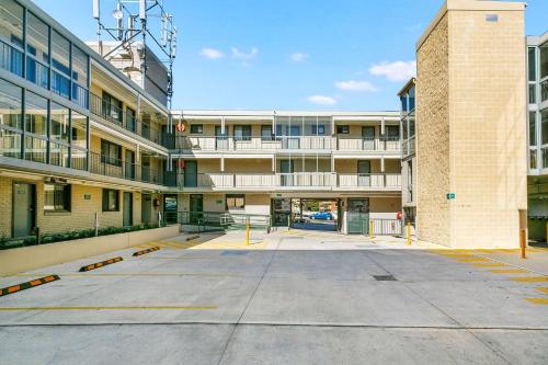 an empty parking lot in front of a building at Quality Inn Sunshine Haberfield in Sydney
