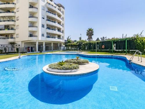 a large swimming pool in front of a building at Apartamento 306 in Marbella