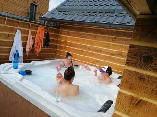 a group of people in a hot tub at Apartments Pemikas I in Liptovský Mikuláš