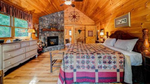 a bedroom with a bed and a fireplace in a cabin at Bear Branches in Blue Ridge