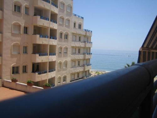 a view from the balcony of a building overlooking the ocean at Apartamento 329 in Marbella