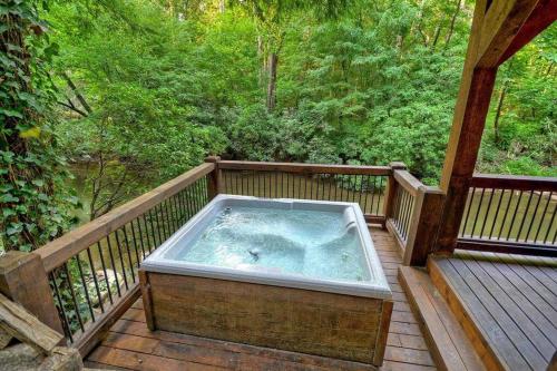a hot tub sitting on a wooden deck at Creekside R&R in Blue Ridge