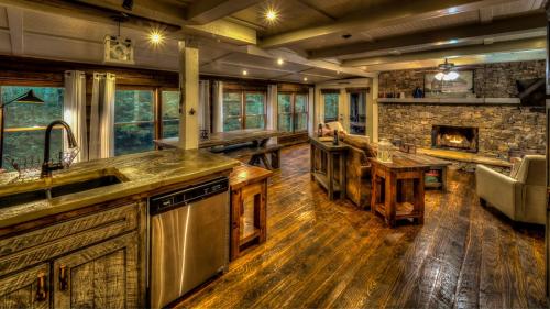 a kitchen with a fireplace and a stone wall at Creekside R&R in Blue Ridge