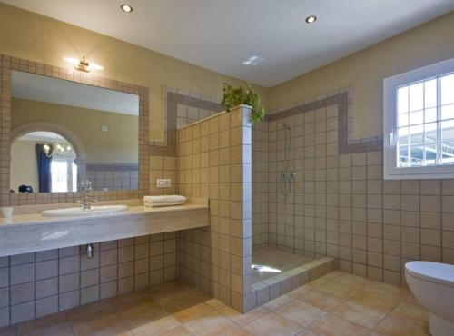 a bathroom with a shower and a sink and a toilet at Villa Gravetes - Plusholidays in Teulada