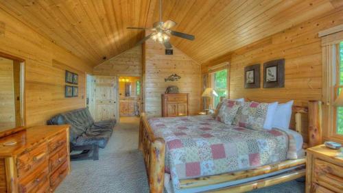 a bedroom with a bed and a chair in a cabin at CloudWalker in Morganton