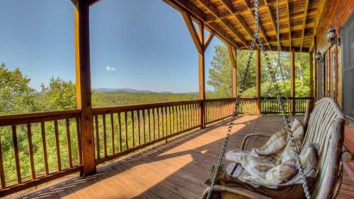 a porch with two swinging chairs on a deck with a view at CloudWalker in Morganton