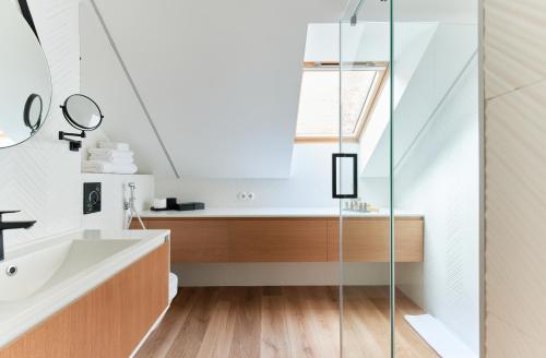 a bathroom with a sink and a shower at Dream Boutique Apartments in Rīga