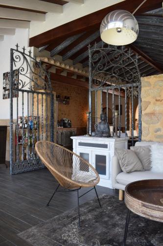 a living room with a white couch and a chair at Casa Mistela in Jalón