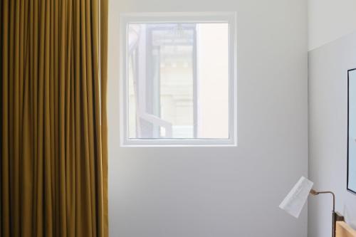 a window in a room with a green curtain at The Durham Hotel in Durham