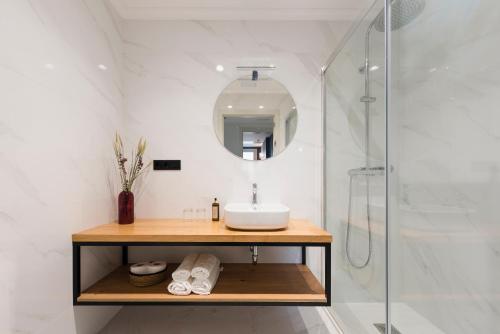 uma casa de banho com um lavatório e uma cabina de duche em vidro. em Rías Altas - Hotel Restaurante em Barreiros