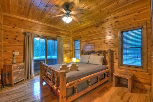 a bedroom with a bed in a log cabin at Forever Joy in Blue Ridge