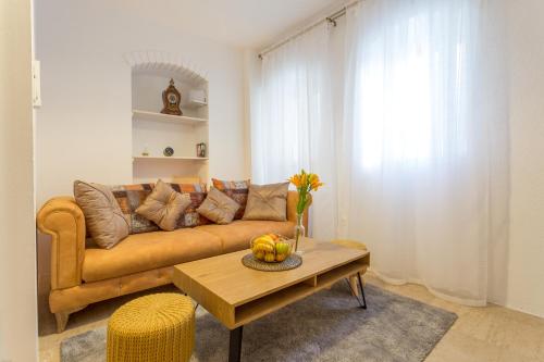 a living room with a couch and a table at Lola Apartments - ZF Hvar in Hvar