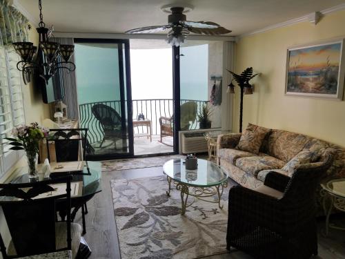 a living room with a couch and a table at The Palms Resort-Oceanfront in Myrtle Beach