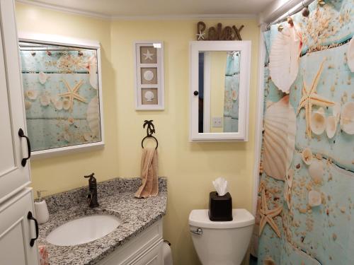 a bathroom with a sink and a toilet and a shower at The Palms Resort-Oceanfront in Myrtle Beach