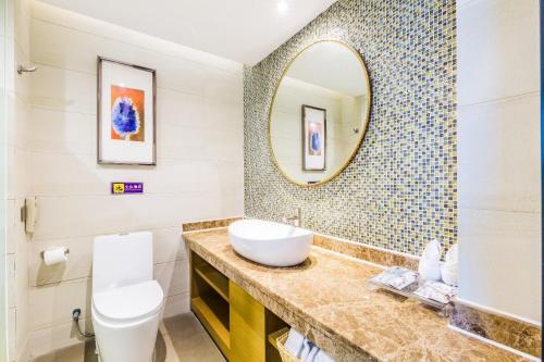 a bathroom with a sink and a mirror at Lavande Hotel Foshan Shunde Ronggui in Shunde