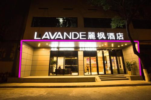 a store with a pink neon sign in front of it at Lavande Hotels·Kunshan Renmin Road in Suzhou