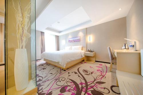 a hotel room with a bed and a desk and a bedroom at Lavande Hotels·Kunshan Renmin Road in Suzhou