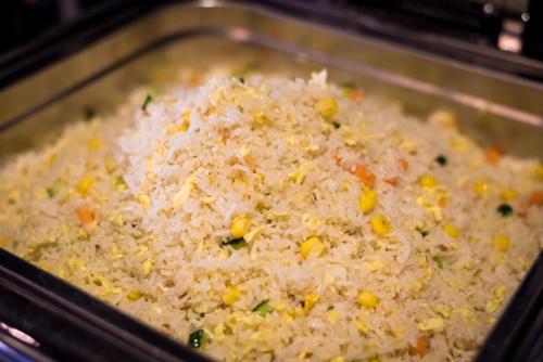 a pan filled with rice with corn and vegetables at Lavande Hotels·Guangzhou East Railway Station in Guangzhou