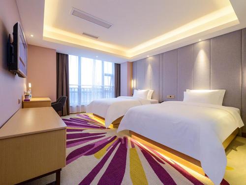 Ένα ή περισσότερα κρεβάτια σε δωμάτιο στο Lavande Hotels·Chengdu Xinjin