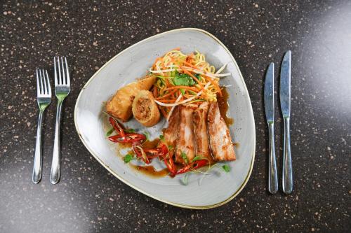 a plate of food on a table with fork and knife at Holiday Inn Telford Ironbridge by IHG in Telford