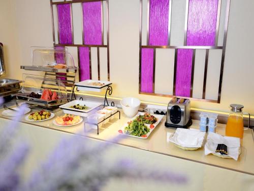 a table with several plates of food on it at Lavande Hotel Xi'an Bell Tower in Xi'an