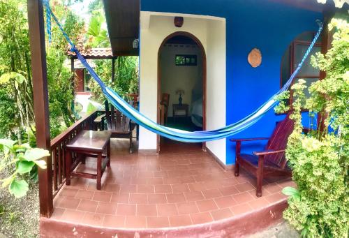 
a patio area with a balcony and a fire place at Hotel El Encanto in Cahuita
