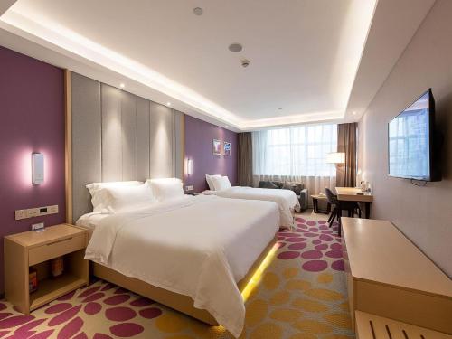 a hotel room with two beds and a television at Lavande Hotels·Guangzhou Beijing Road Pedestrian Street Haizhu Square Metro Station in Guangzhou