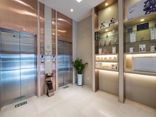 a bathroom with a walk in shower and a pharmacy at Lavande Hotel Beijing Railway Station in Beijing