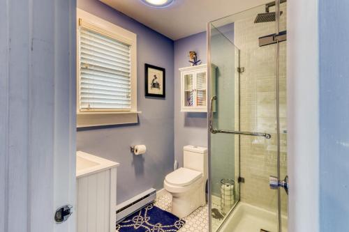 a bathroom with a toilet and a glass shower at Provincetown Waterfront Studio in Provincetown