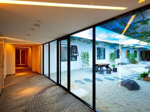 a hallway of a building with large glass windows at Lavande Hotels·Guilin Central Square Elephant Trunk Hill Scenic Area in Guilin