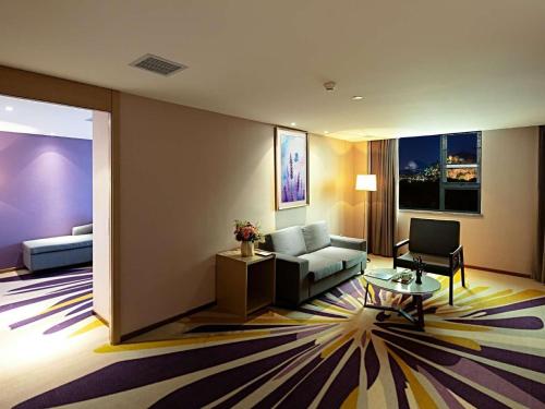 a living room with a couch and a table at Lavande Hotels·Guilin Central Square Elephant Trunk Hill Scenic Area in Guilin