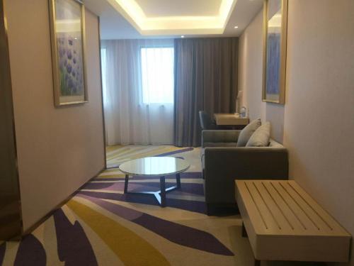 a living room with a couch and a table at Lavande Hotels·Guilin Central Square Elephant Trunk Hill Scenic Area in Guilin