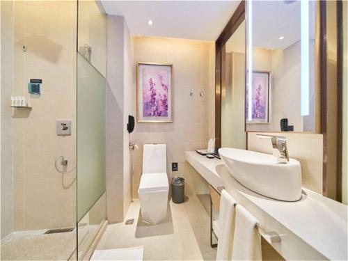 a bathroom with a sink and a toilet and a shower at Lavande Hotels·Foshan West Railway Station Luocun in Foshan