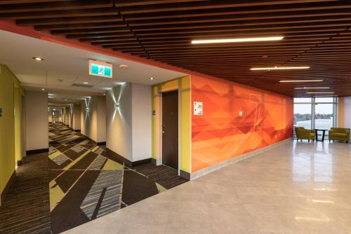an empty hallway with colorful walls in a building at Holiday Inn Express & Suites - Saskatoon East - University by IHG in Saskatoon