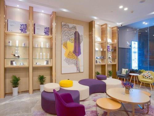 a room with purple chairs and tables and shelves at Lavande Hotels·Nanjing South of Olympic Stadium Daishan New Town in Nanjing