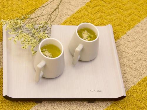 two cups of coffee sitting on a plate at Lavande Hotels·Nanjing South of Olympic Stadium Daishan New Town in Nanjing