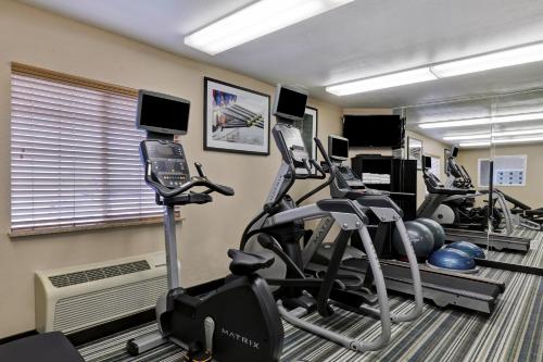 a fitness room with several cardio machines and a cell phone at Candlewood Suites Indianapolis - South by IHG in Greenwood